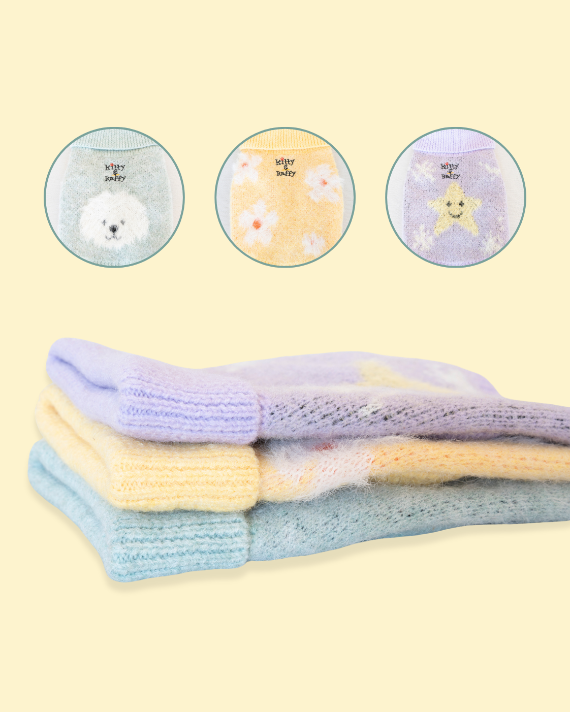 A 3 set of knitted jumpers specially designed for Comfort Me Raffy. One features a dog's face, one features white daisies and the final features a yellow star design