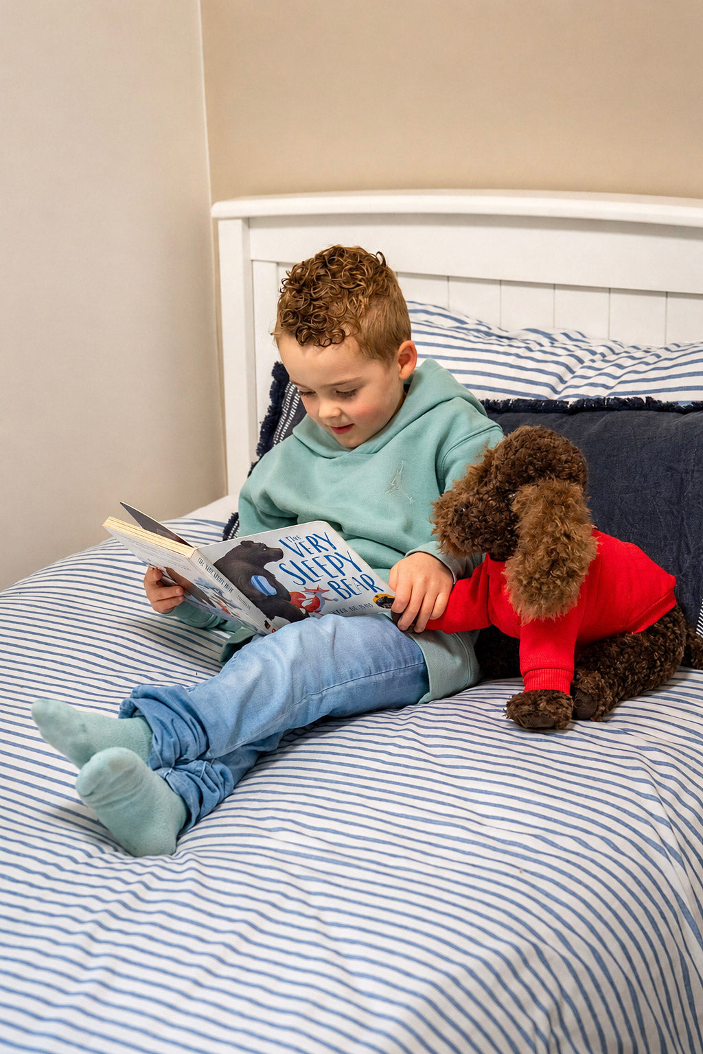 A child reading with Raffy alongside them